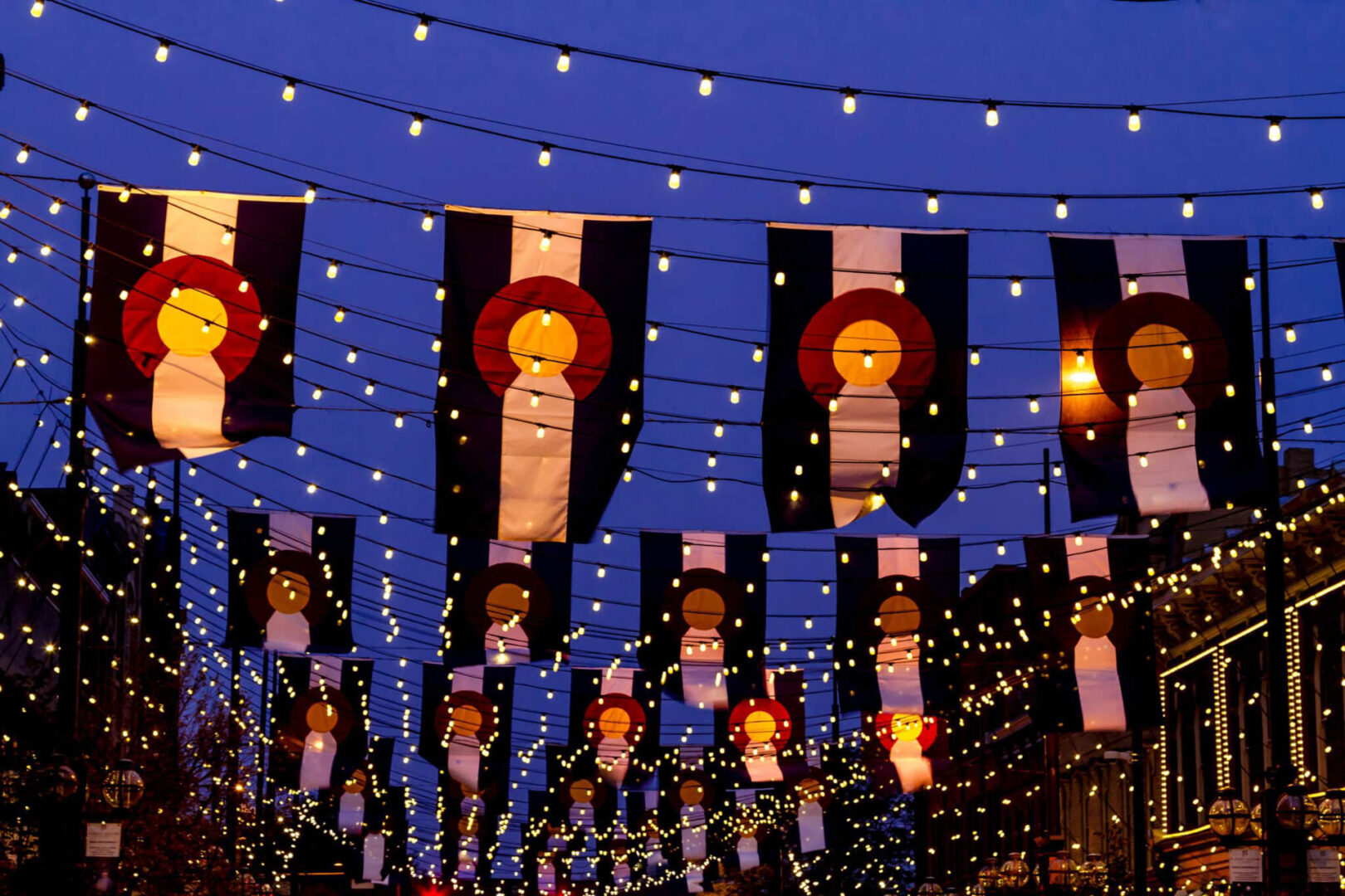 Colorado Flags hanging with small lights on Historic Larimer Square in Denver Colorado