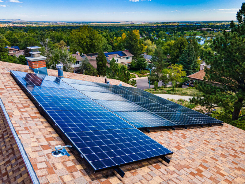 residential solar panels, green trees on horizon