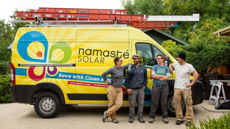 namaste solar employees next to company van