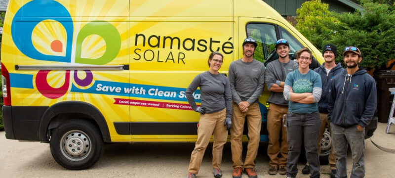 6 employees in front of namaste solar yellow van